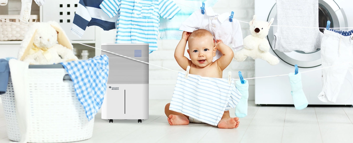 Child interacting with MyCond Roomer Hepa 25 dehumidifier in a bathroom setting.